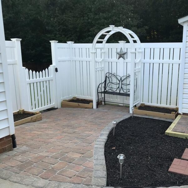Weldon white semi-privacy fence with decorative arbor