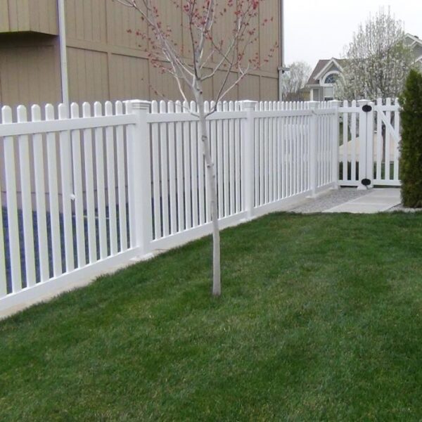 Murton white vinyl picket fence with budding tree