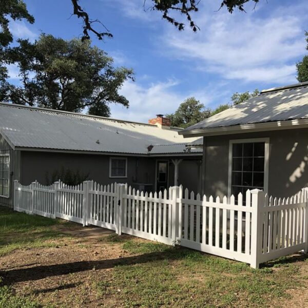Grantham white vinyl picket fence stepped alternate angle