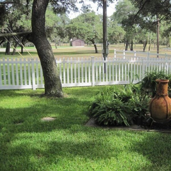 Burton white vinyl picket fence on green lawn