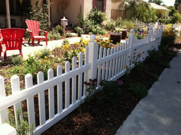Darlington White vinyl picket fence in a garden