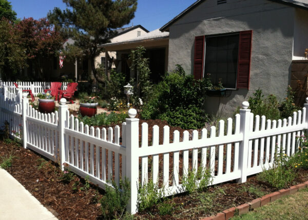 Darlington White vinyl picket fence in a garden 2nd view